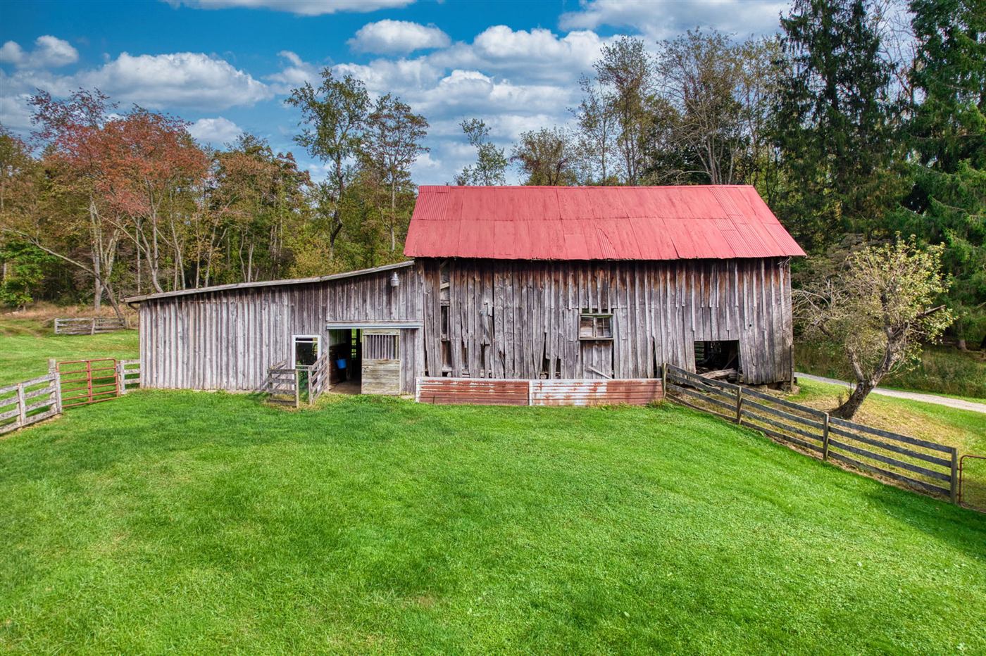 Weathered bank barn with red roof