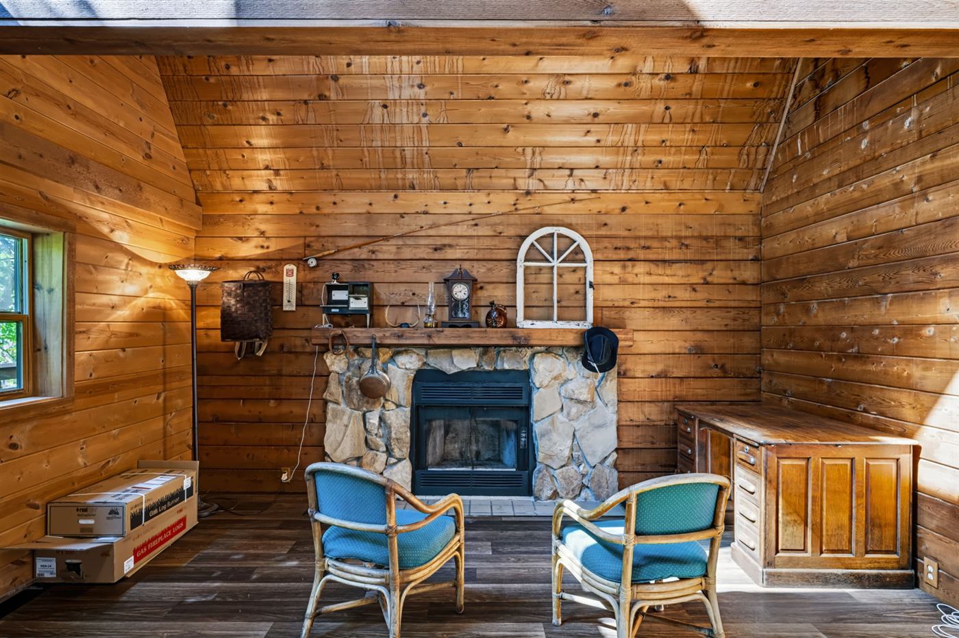 Stone fireplace in a wood-paneled room