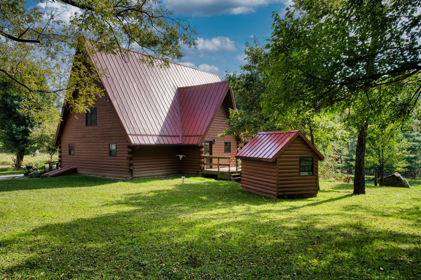 Side view of the log home among trees